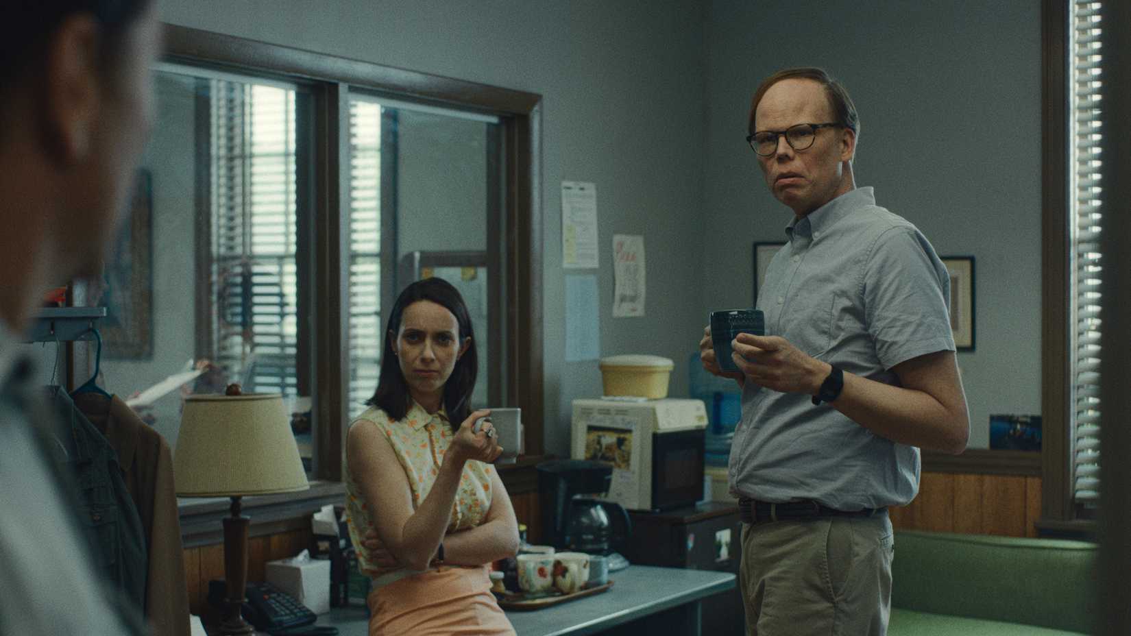 Patricia and Dale drinking coffee and talking in the office in Widow's Bay.