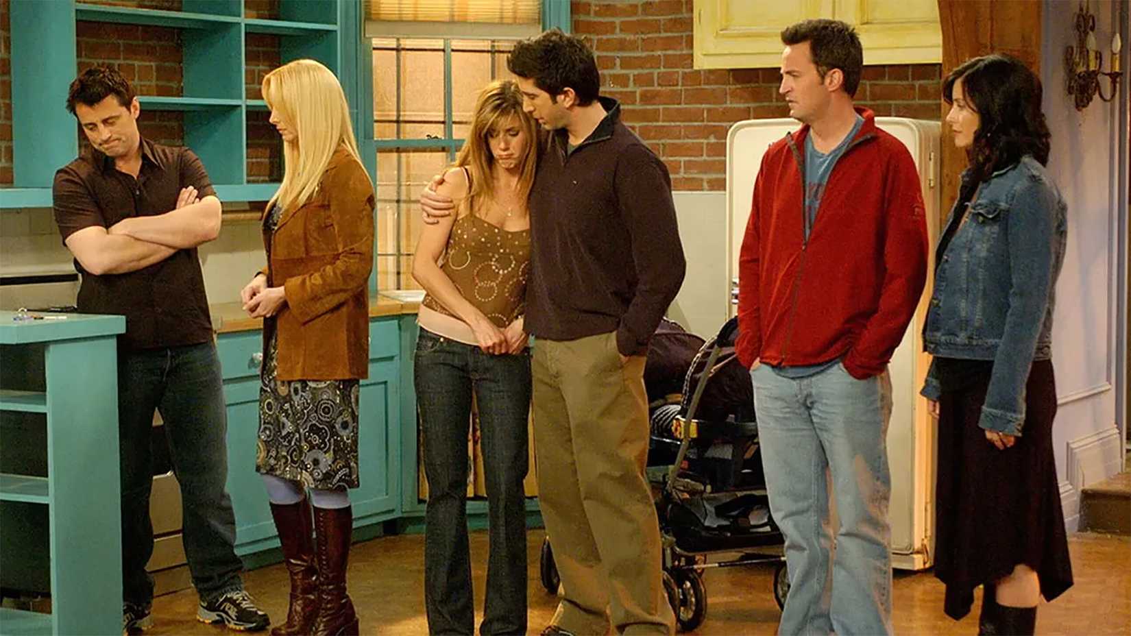 The six friends standing in Monica's apartment in Friends.
