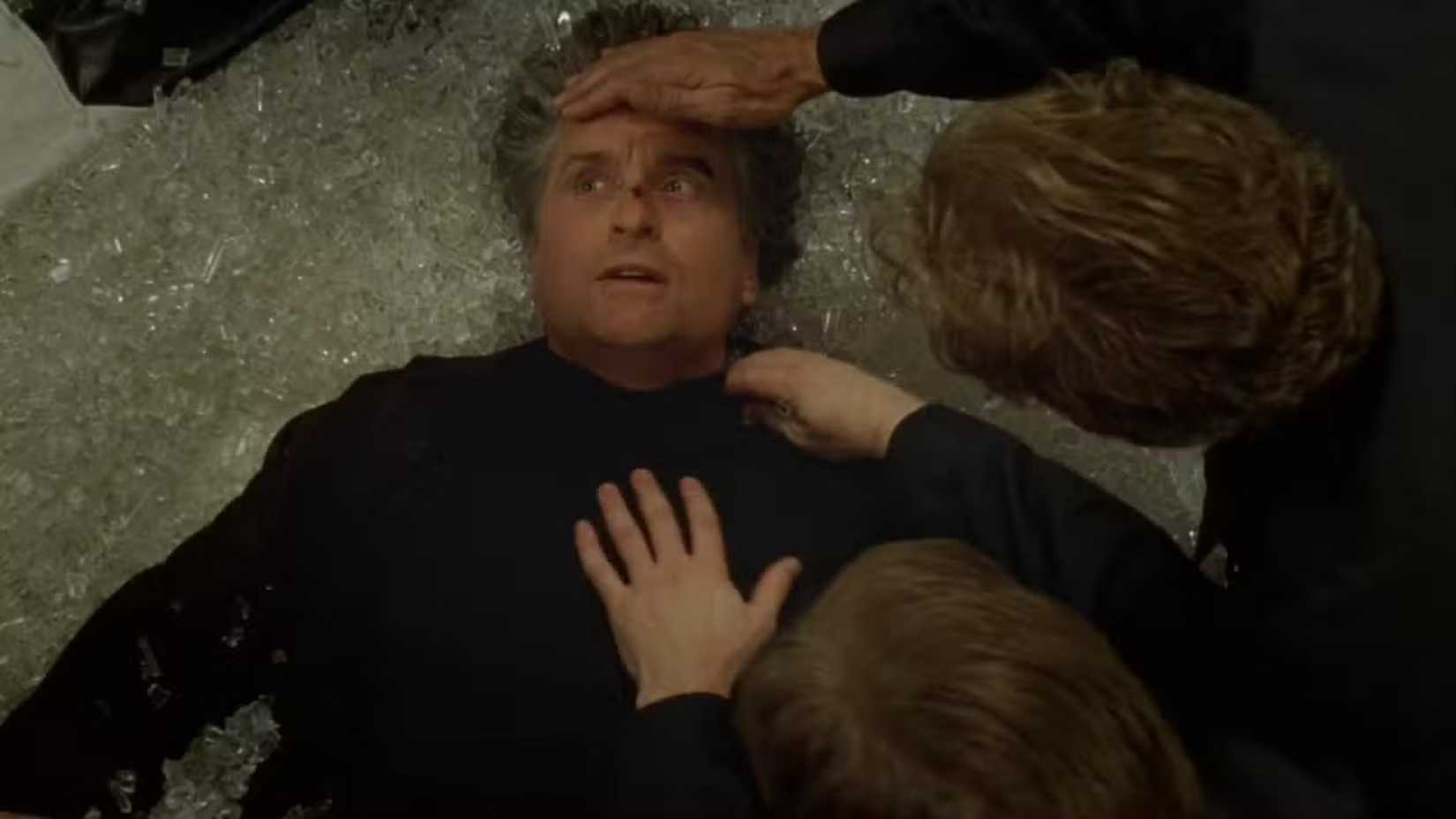 People help Michael Douglas while he's laying on the floor in The Game