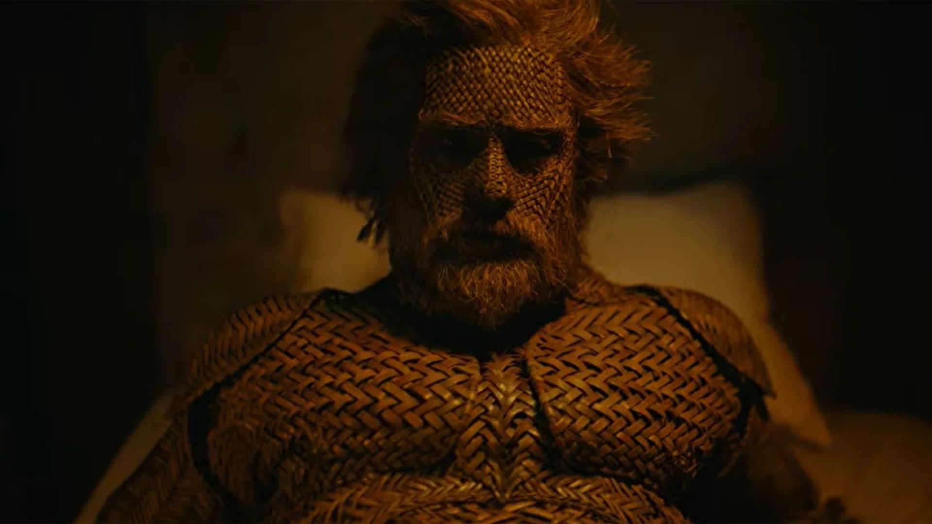 A whimsical depiction of Alexander Skarsgård’s character, made from wicker, engaged in a fanciful moment with Olivia Colman’s fishwoman.