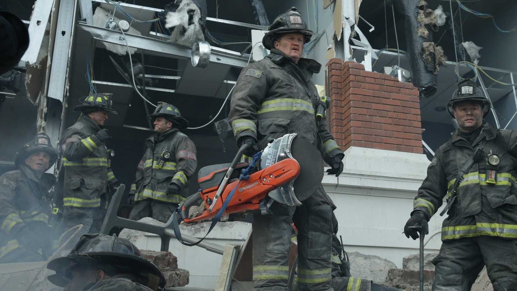 The crew stands outside a building in Chicago Fire