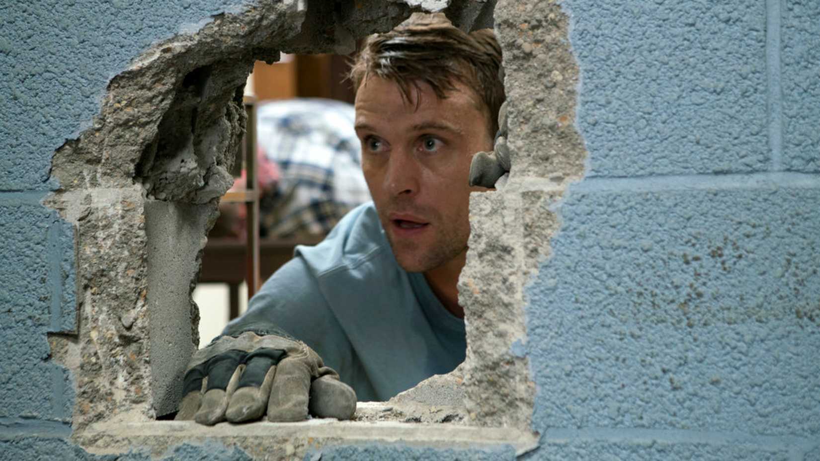 Casey peers through a wall in Chicago Fire