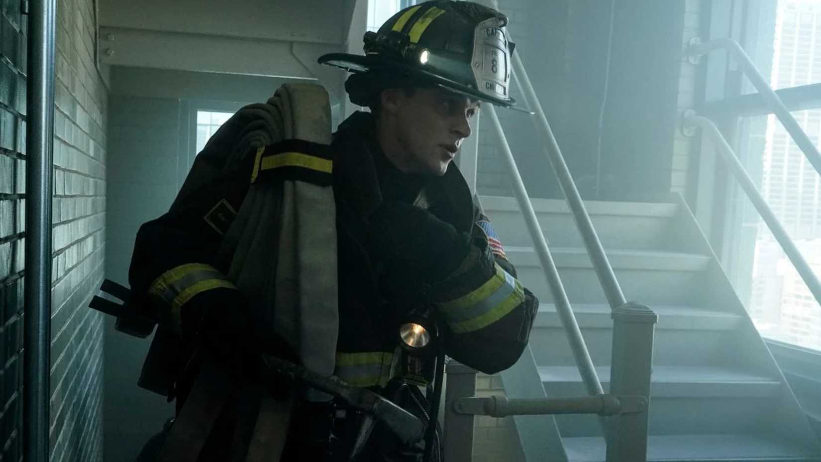Casey carries a hose in Chicago Fire
