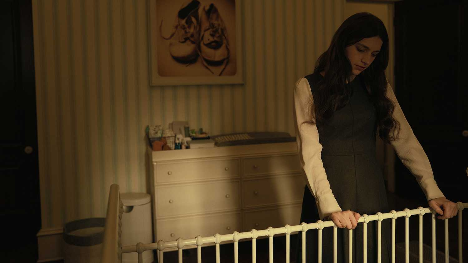 Leanne looking into a crib in Servant.