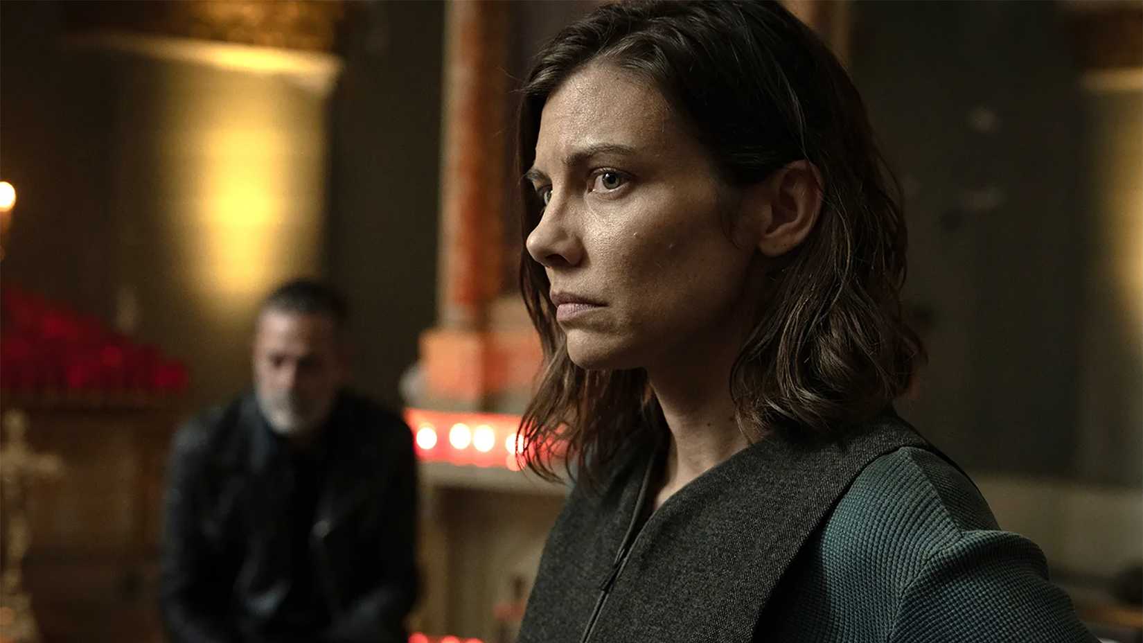Maggie looking worried, Negan blurred out in the background in The Walking Dead: Dead City.