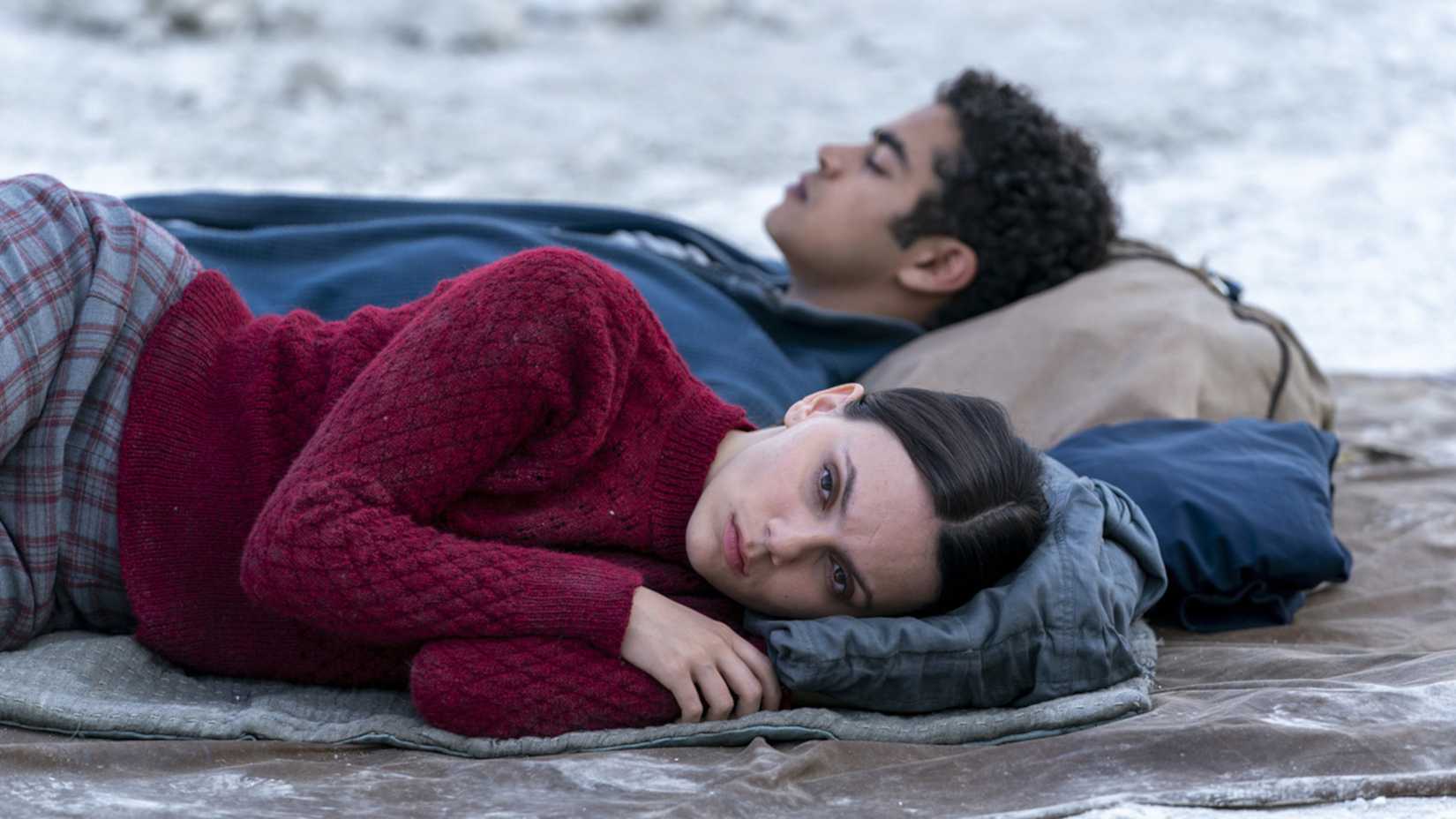 Lyra and Will lying on the ground in His Dark Materials