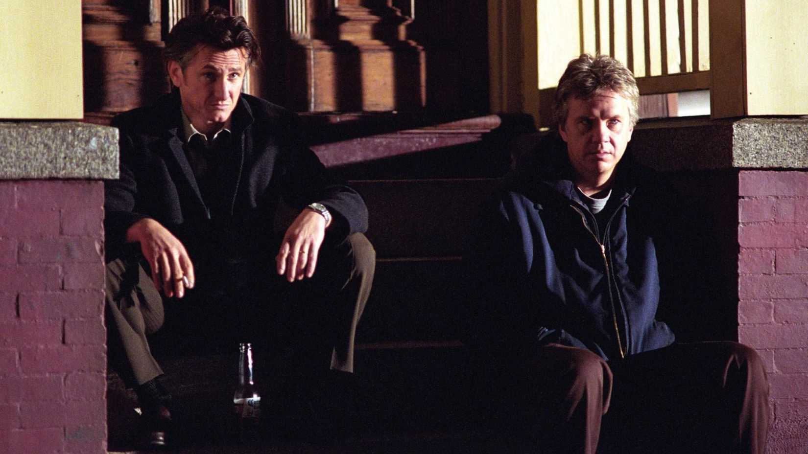 Jimmy and Dave sit on the steps in Mystic River
