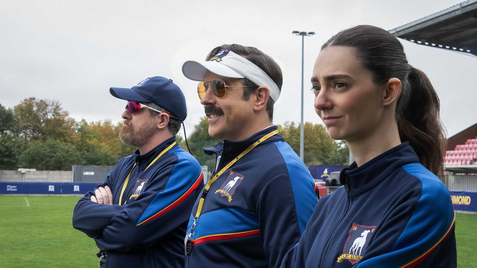 Coach Beard, Ted, and Alice standing in a row in Ted Lasso.