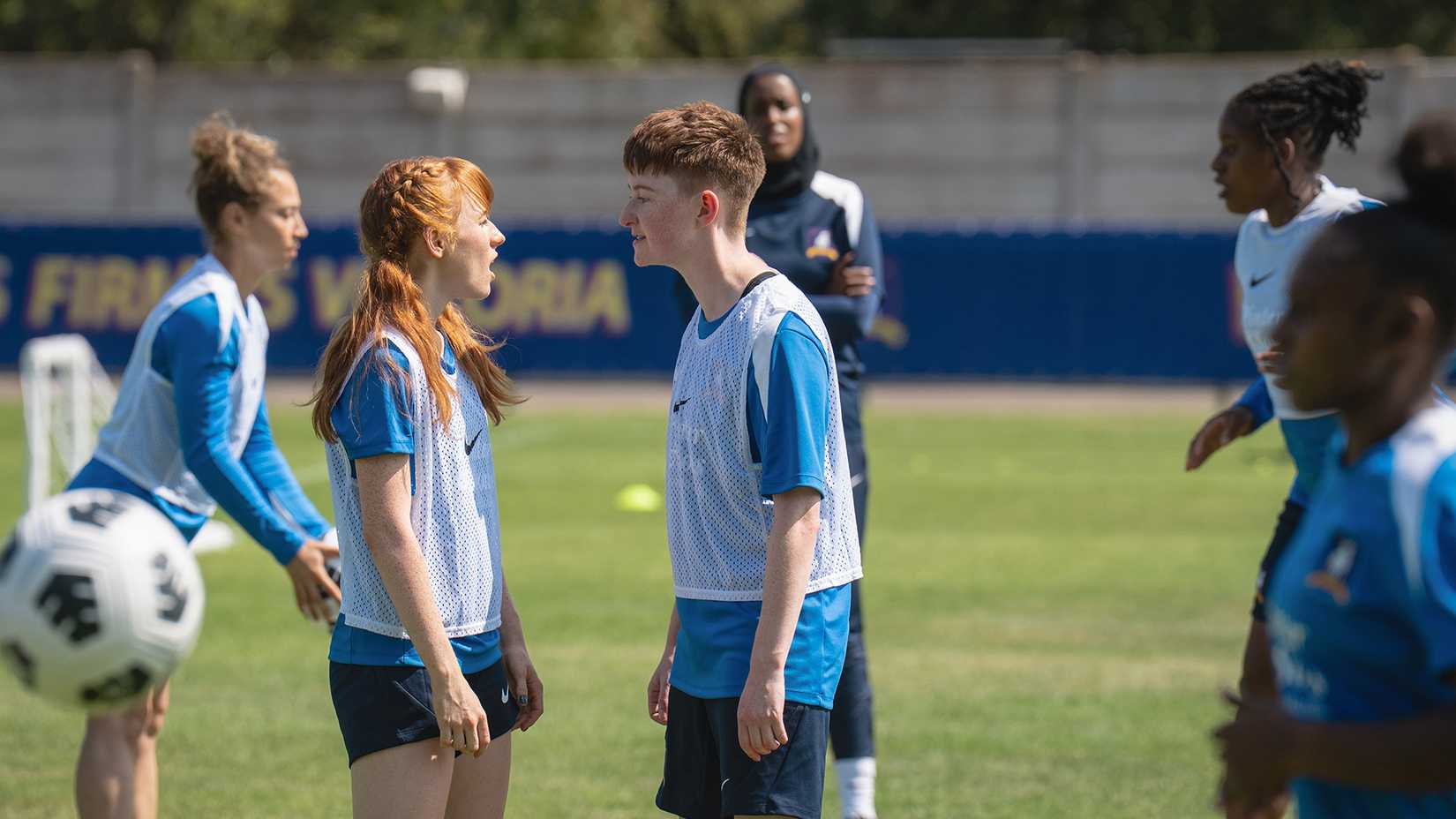 Two female players arguing on the field in Ted Lasso.