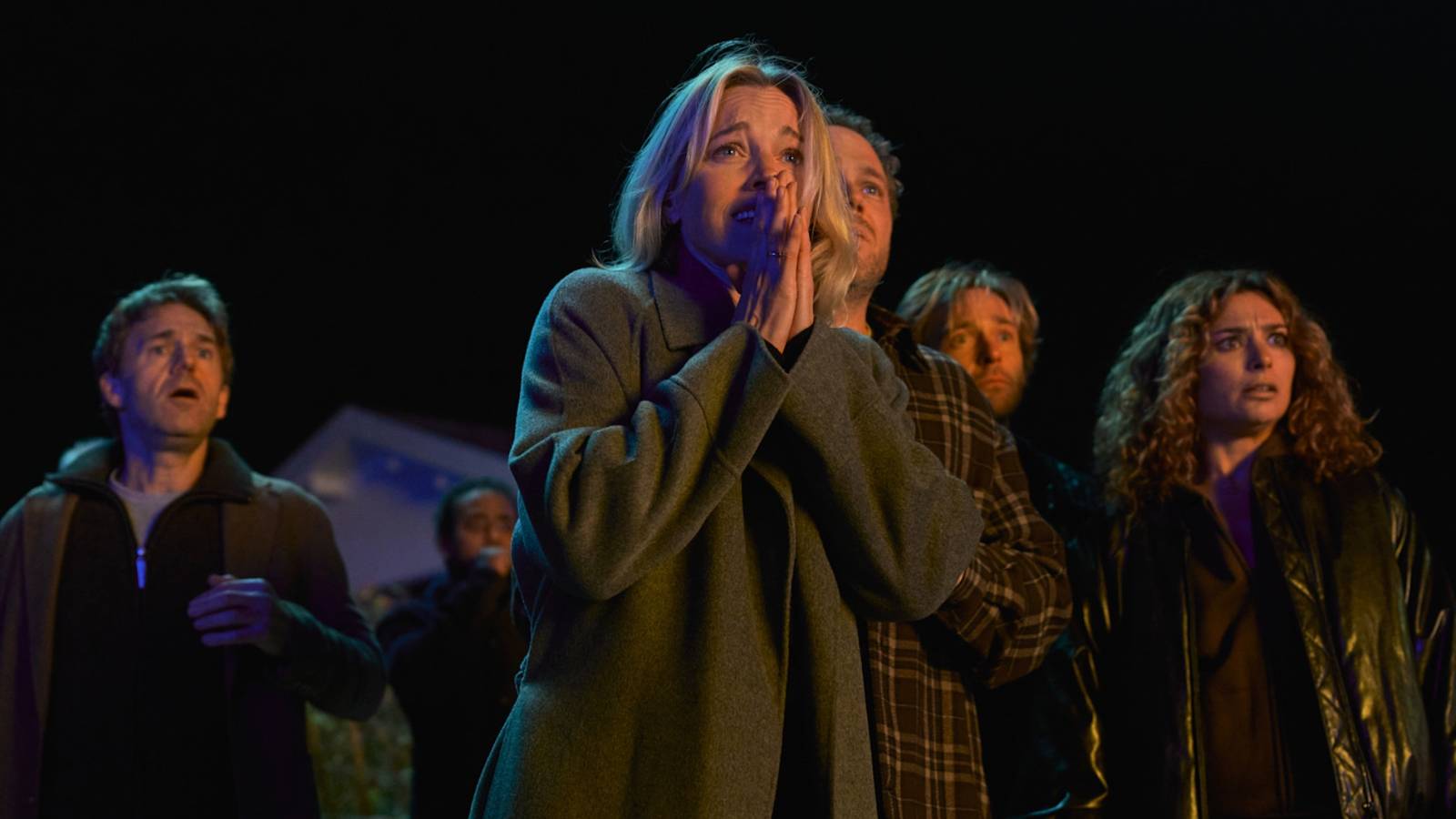 A group of people look concerned in the series The Perfect Lie