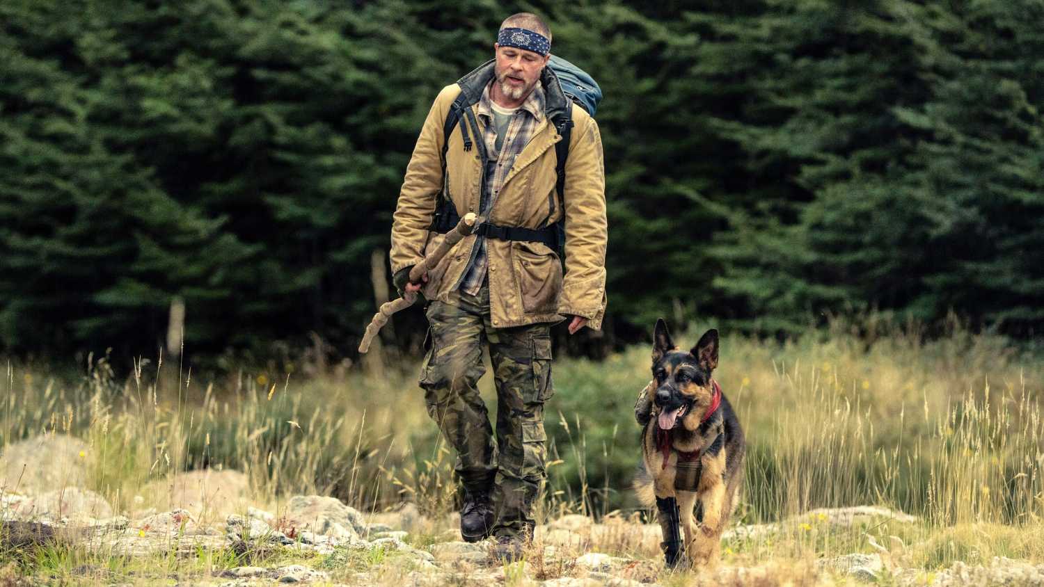 Brad Pitt As James Belmont And His Dog Odin Walking Through A Forest Clearing In Heart of the Beast
