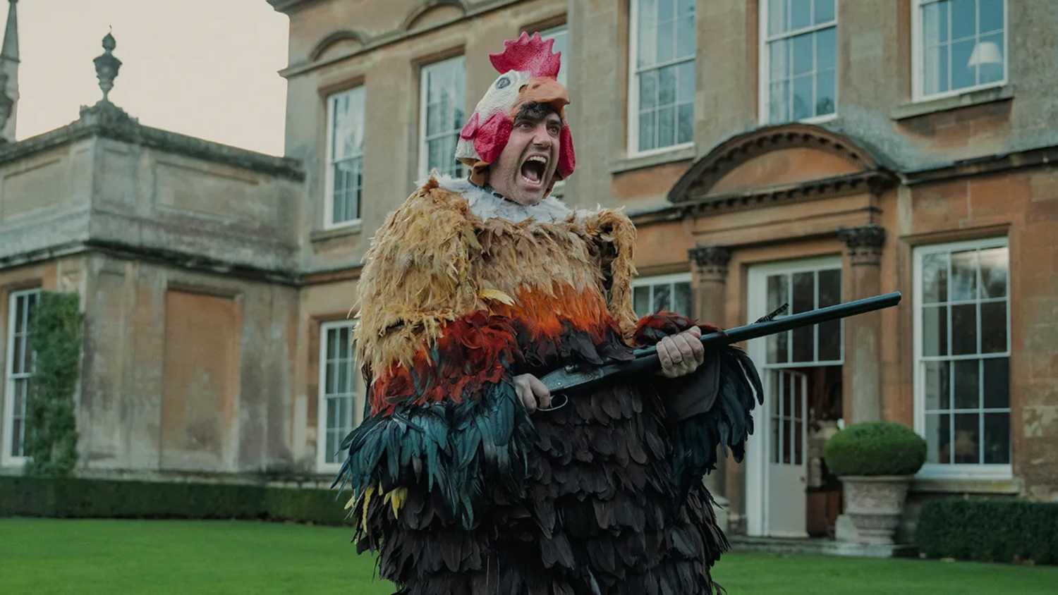Daniel Ings wearing a chicken suit in the gentlemen