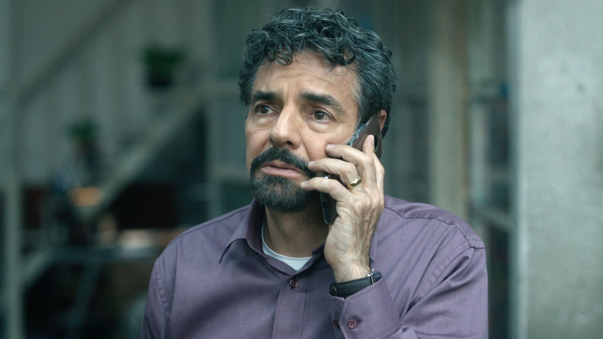 eugenio Derbez uses a phone in The Trial