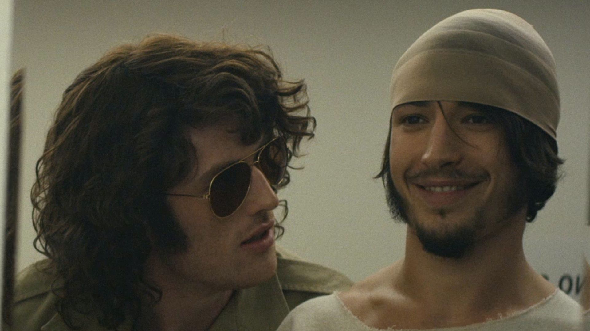 Ezra Miller smiling as a prison guard stares him in the face in The Stanford Prison Experiment (2015)