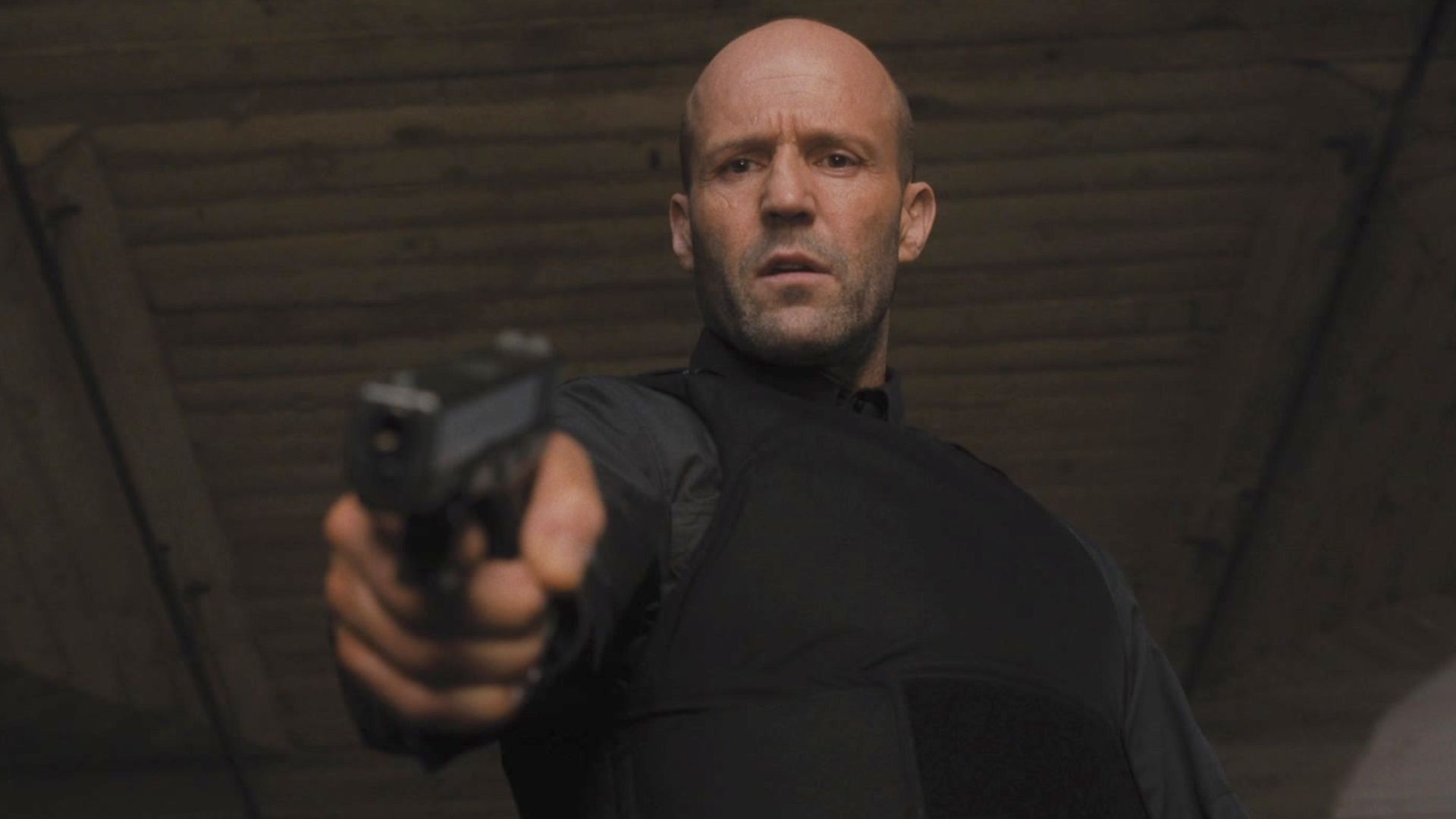 Jason Statham points a gun in the film Wrath of Man