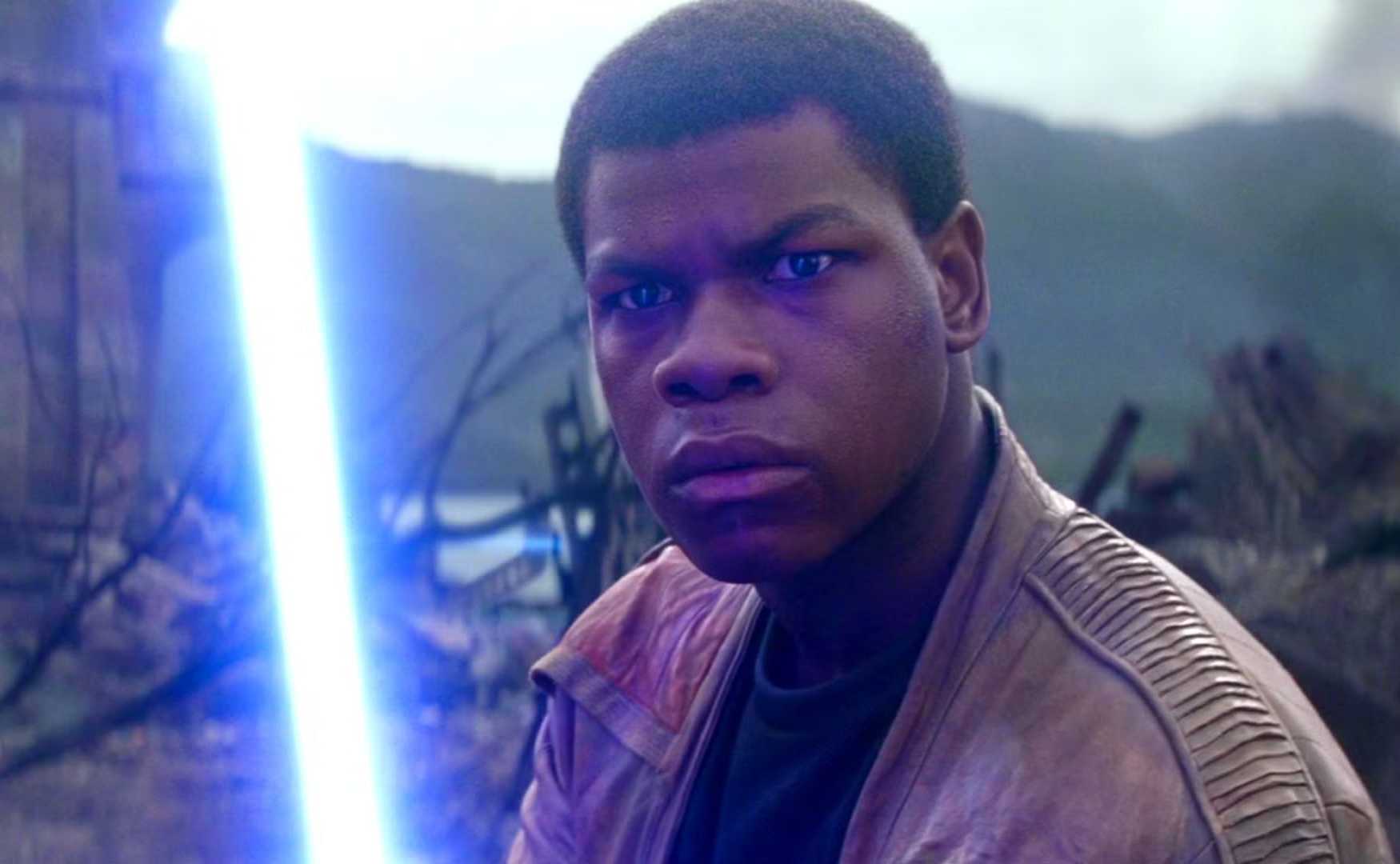 John Boyega Holding a Lightsaber as Finn in Star Wars The Force Awakens