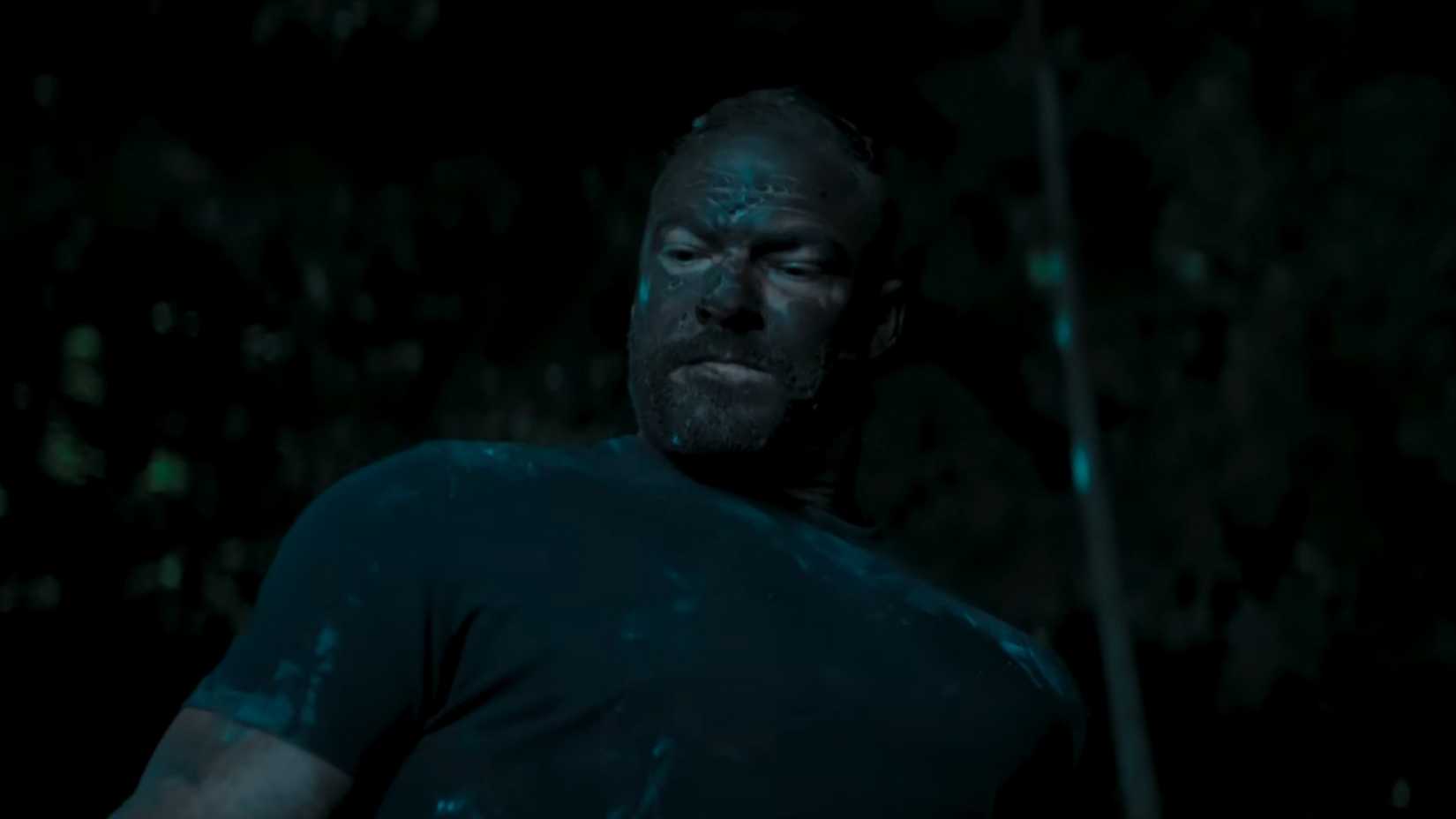 Reacher fighting in the woods