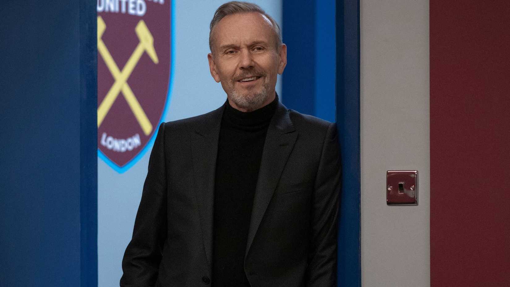Anthony Head as Rupert leaning against a door frame in Ted Lasso.