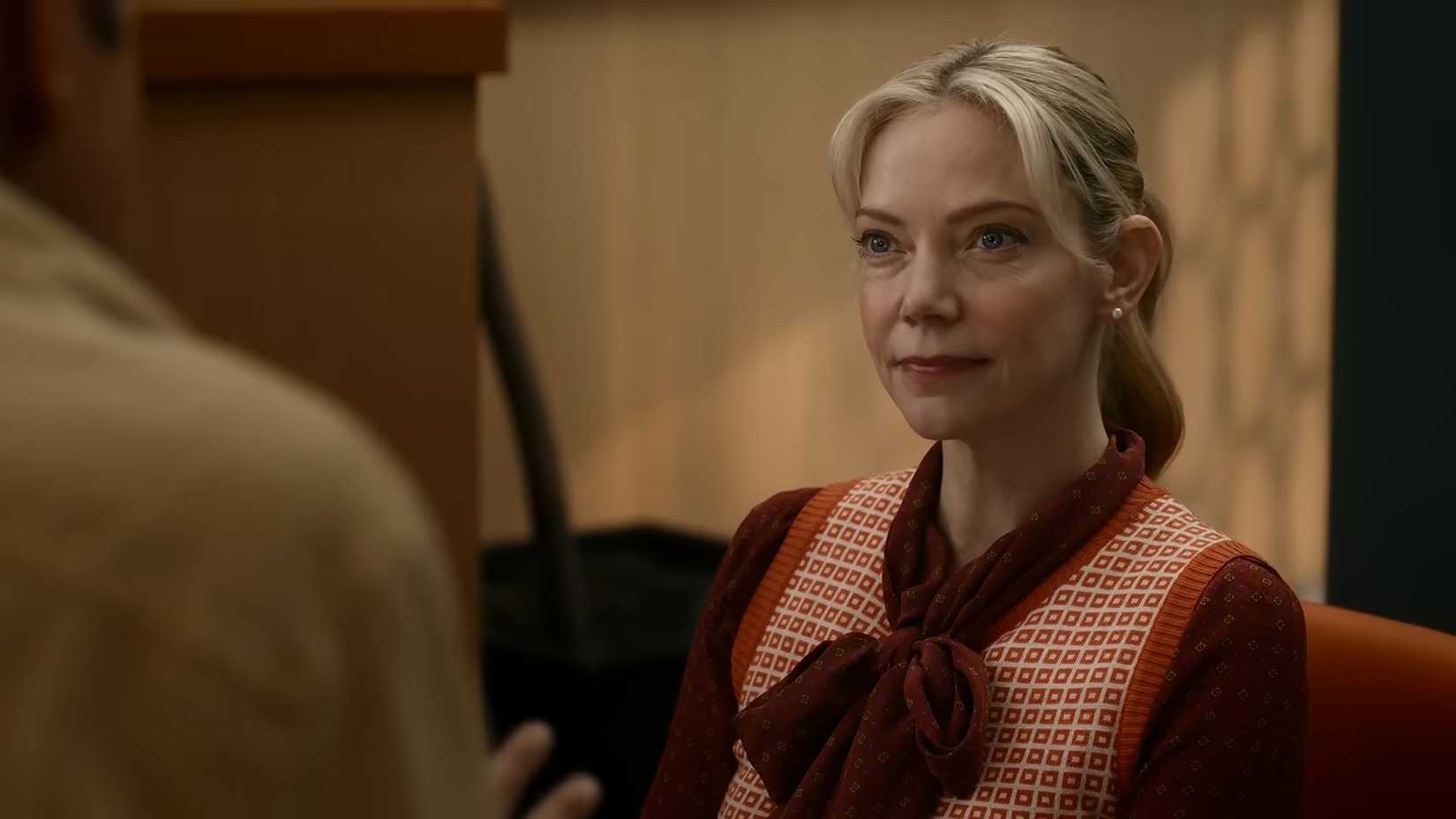Riki Lindhome as Ramona Nowitzki listening to Kripke talk to her in Stuart Fails To Save The Universe.