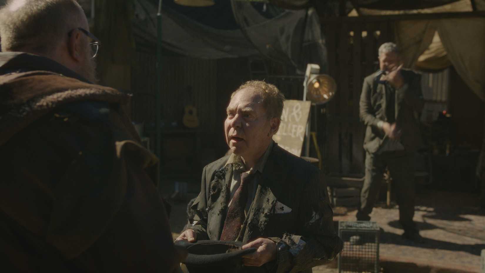 Teller as himself holding his hat out to Bert in Stuart Fails to Save the Universe.