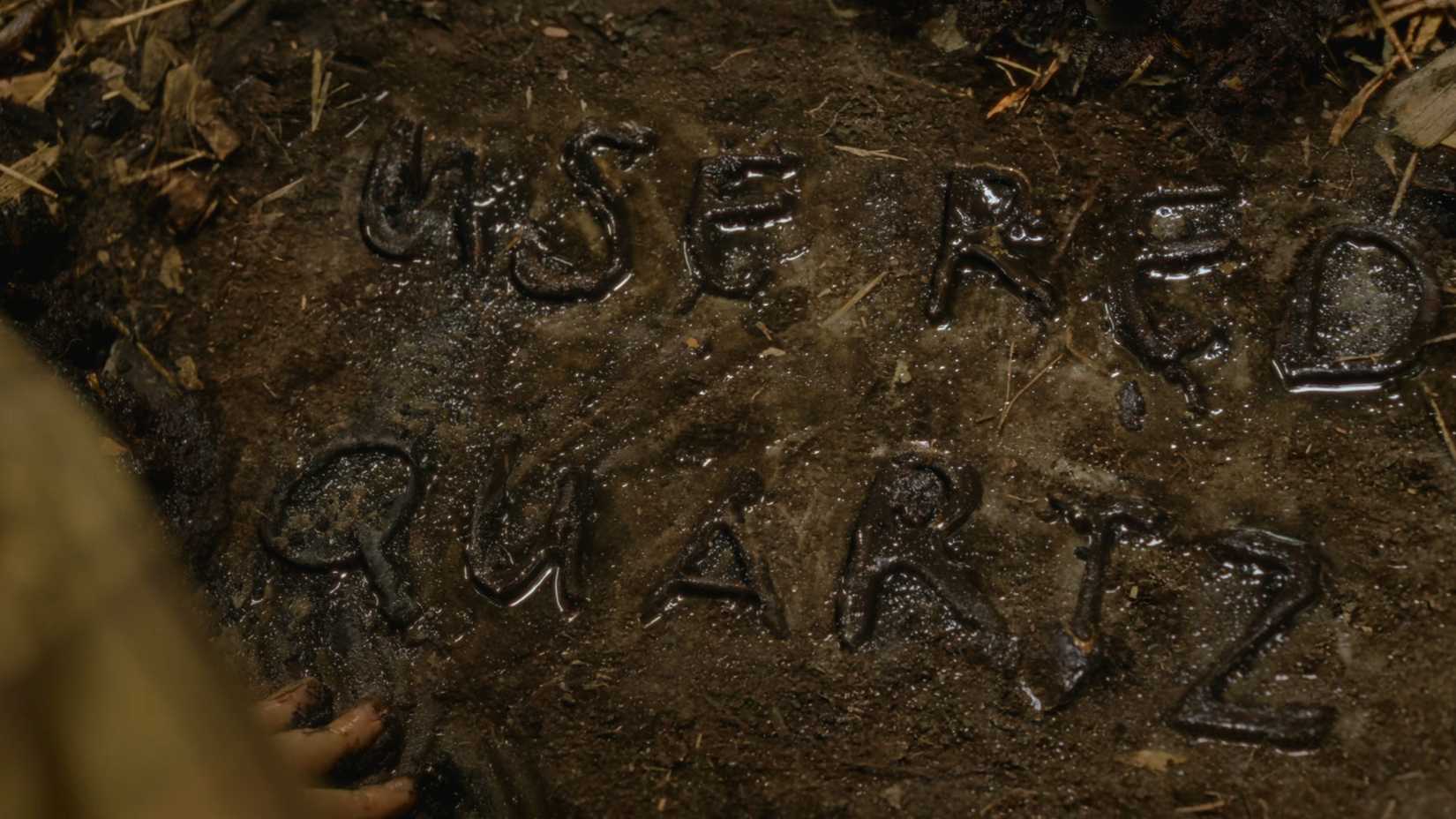 A message written in dirt that reads 
