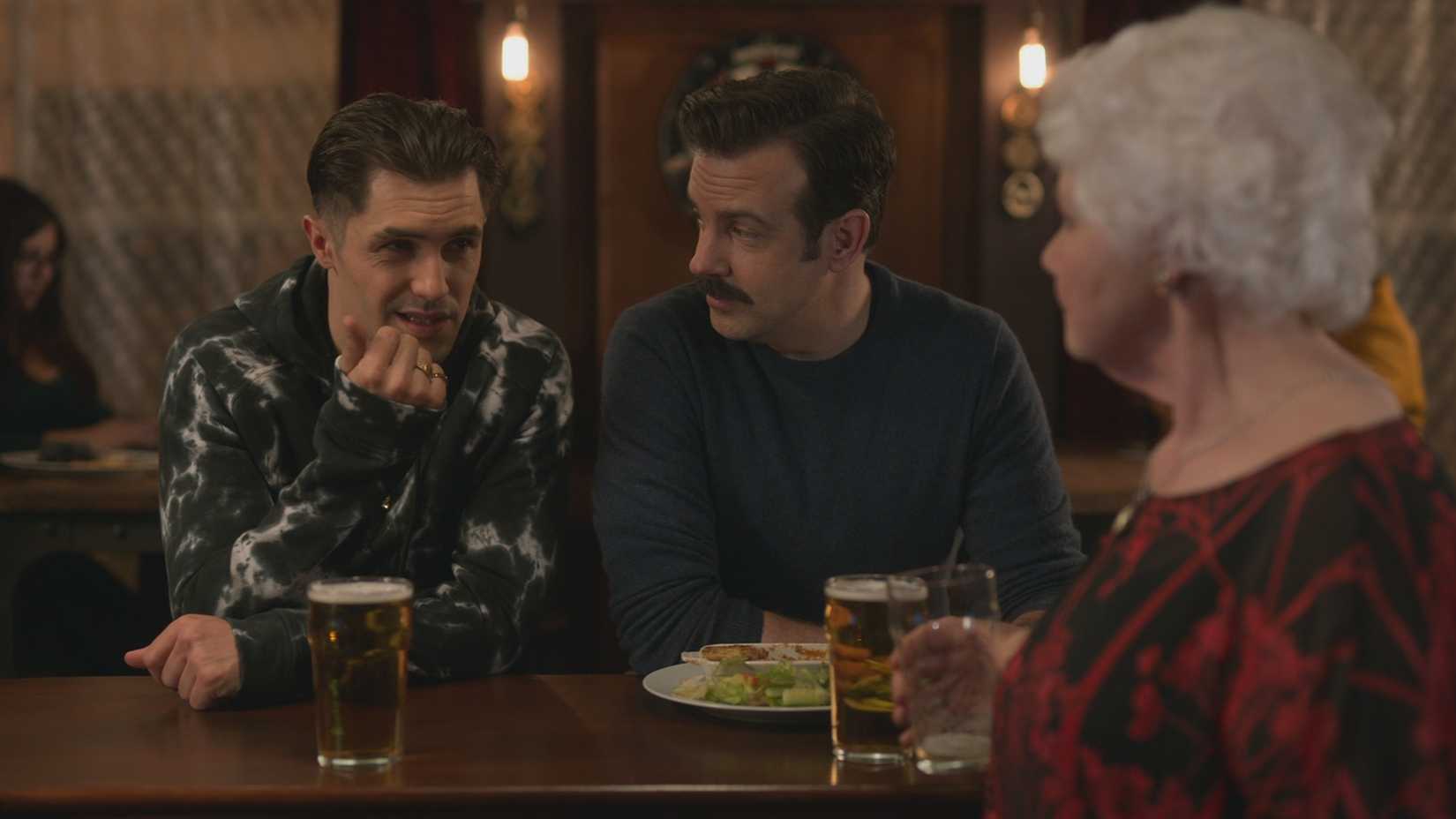 Jamie and Ted sitting at the bar in the Crown and Anchor, talking to Mae, in Ted Lasso.
