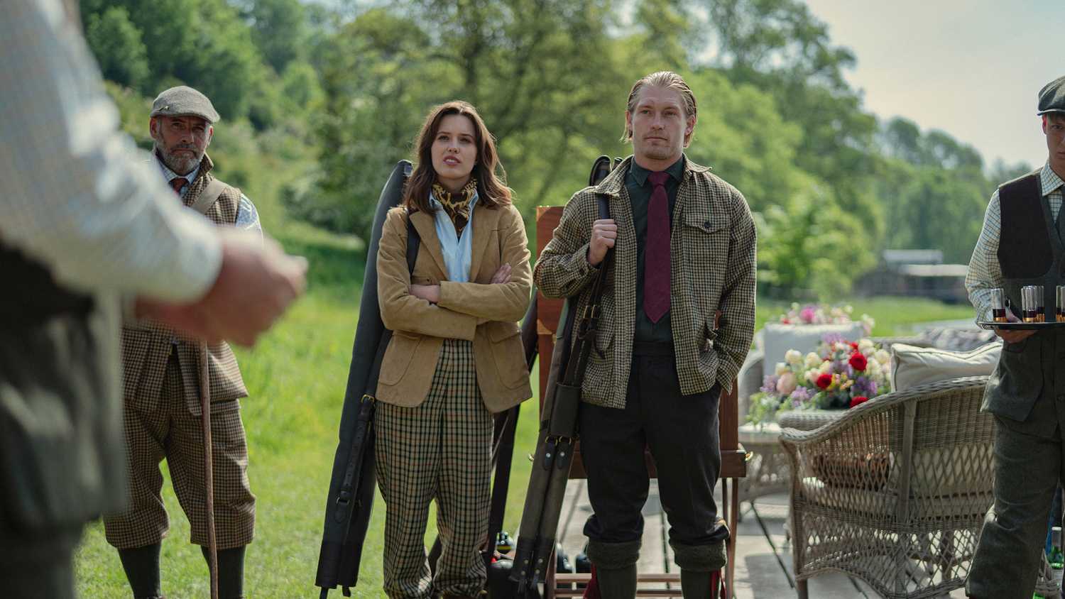 Gabrielle and Jack stood together during the shooting party, carrying guns, in The Gentlemen Season 2.
