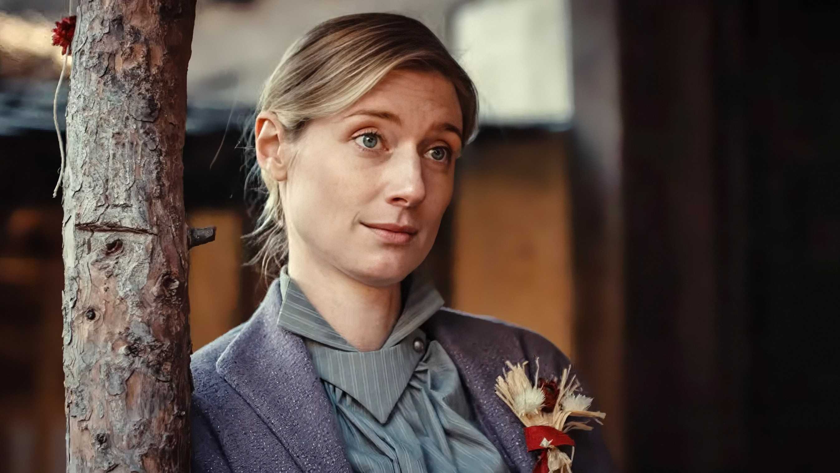 Elizabeth Debicki as the Tailor's Wife Leaning Against A Support Beam In Wicker