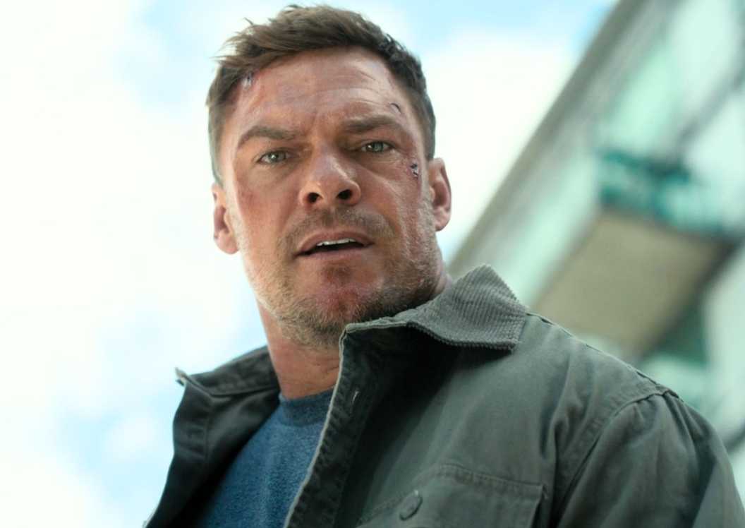 Alan Ritchson looking shocked as Jack Reacher in Reacher