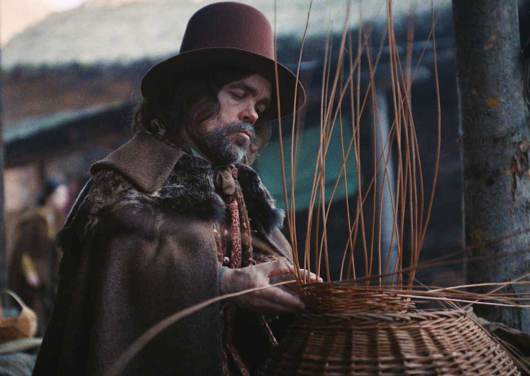 Peter Dinklage as the Basket Weaver weaving a wicker basket in Wicker