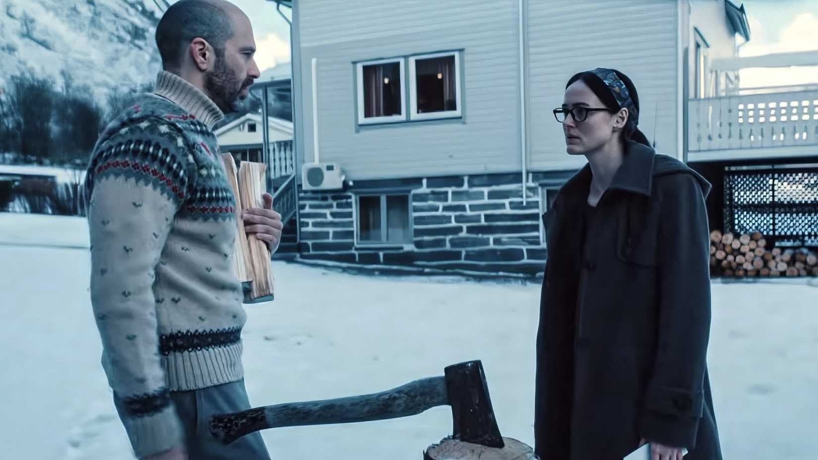 Sebastian Stan and Renate Reinsve Standing In The Snow Beside An Ax In Wood In Fjord