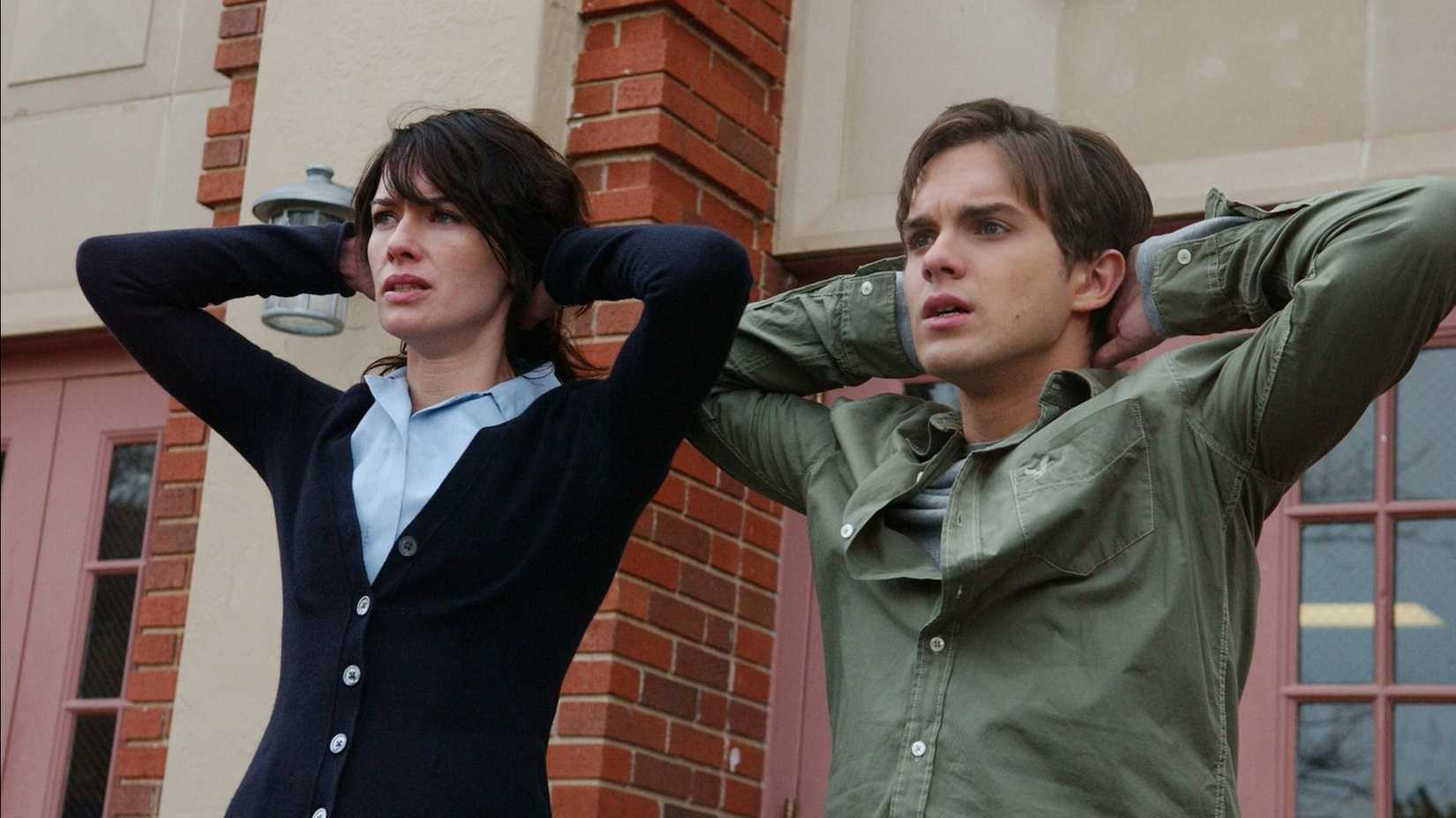 Sarah and John Connor with their hands behind their heads in Terminator: The Sarah Connor Chronicles.